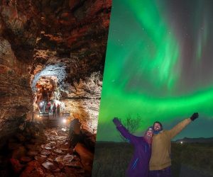 Small group touring inside lava cave in Iceland, couple standing together, posing underneath the nothern lights in Iceland.
